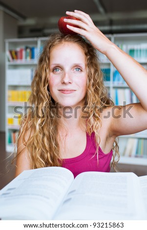 pretty female college student in a library (shallow DOF; color toned image)