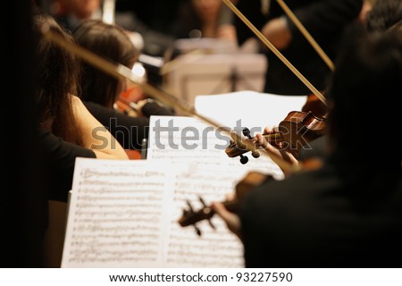 violinists during a classical concert music Royalty-Free Stock Photo #93227590