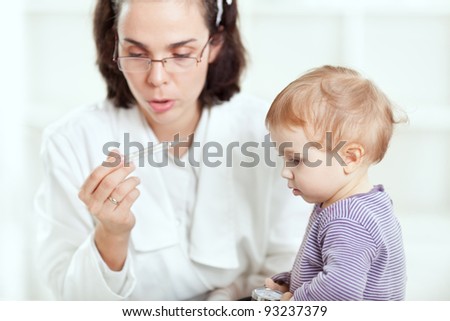 Doctor measuring temperature to a baby