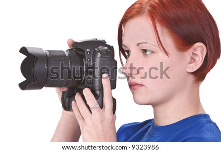 Profile of a redheaded girl taking photos with a DSRL camera.