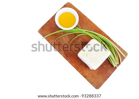 diet food : greek feta white cheese served on wooden plate isolated over white background