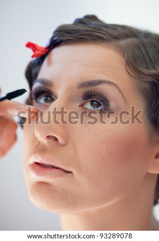 Make up artist doing brides make up for her wedding day. Picture shot with shallow depth of field