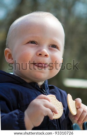Boy with cookies puts out the tongue
