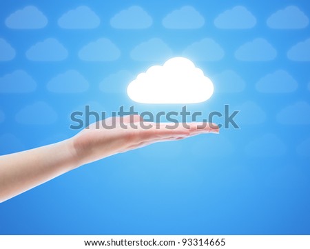 Woman hand share the cloud against blue background with clouds. Concept image on cloud computing theme with copy space.