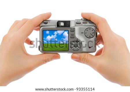 Photo camera in hands and landscape (my photo) isolated on white background