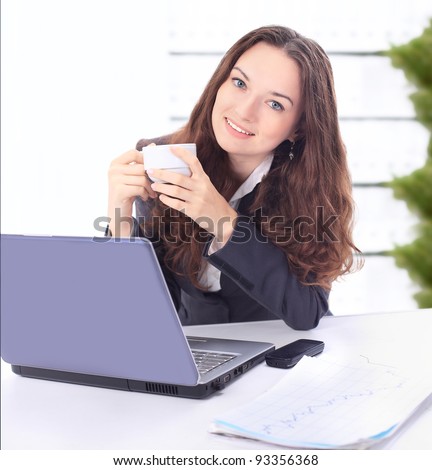 Beautiful businesswoman with a cup of coffee in the office.