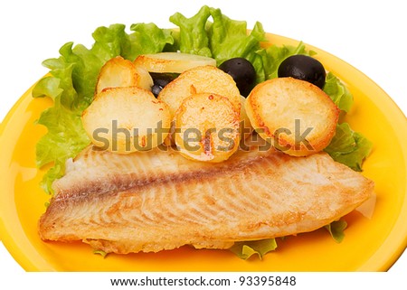 Tilapia with roasted potatoes and olives on a yellow plate