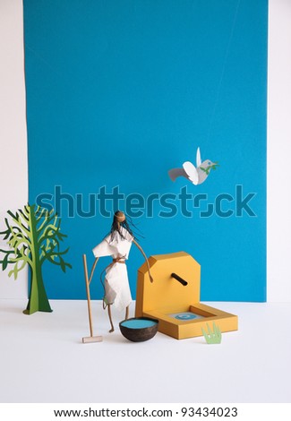 Japanese female figure and a peace dove made of paper