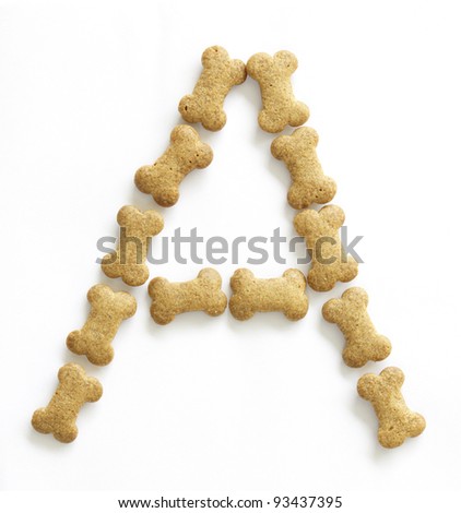 Letter A made of bone shaped dog food on white background, shot directly from above