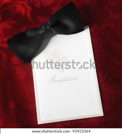 Invitation, with black bow tie over rich red brocade background.