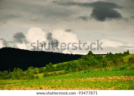 Thunderstorm clouds over the fields in mountains