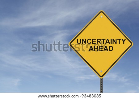 "Uncertainty Ahead” sign on a background of blue sky with clouds Royalty-Free Stock Photo #93483085