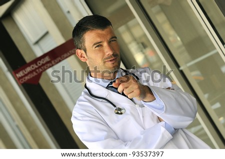 portrait of doctor in front an entrance of the hospital