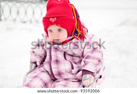 child sitting in sledge