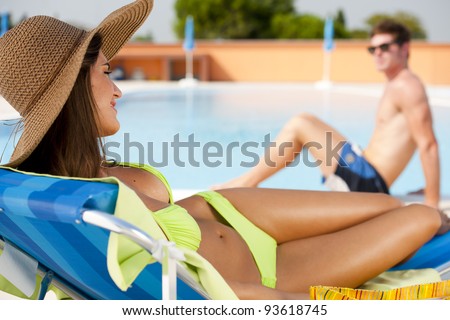 Young woman and man at swimming-pool