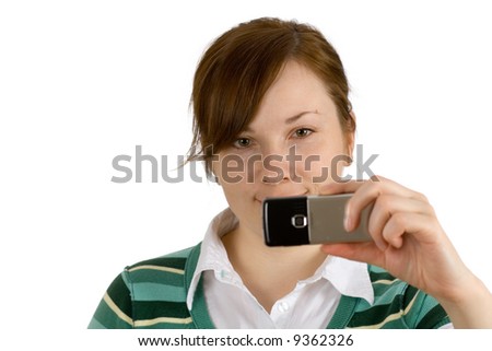 woman isolated on white background holding her mobile phone, looking at screen and taking picture with phone camera