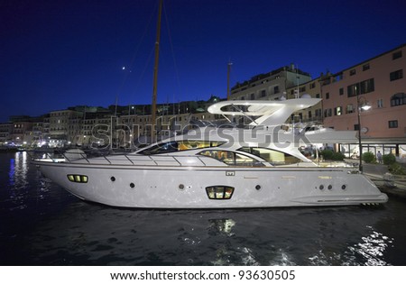 Italy, Tuscany, Elba Island, view of Porto Azzurro and luxury yachts in the marina at night