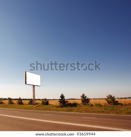 Road in a village with an empty billboard
