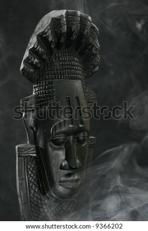 African Tribal Mask surrounded by smoke