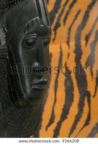 African Tribal Mask with tiger skin in background