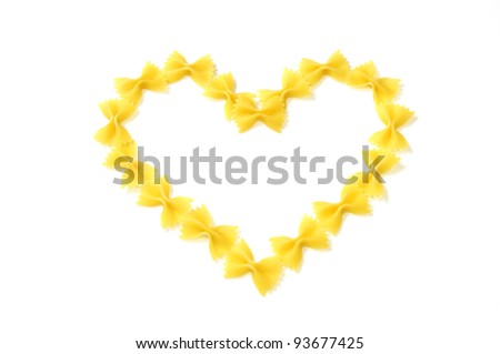 Closeup of italian pasta  a heart shape, farfalle isolated on white  background