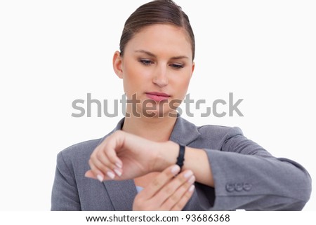 Businesswoman checking her watch against a white background