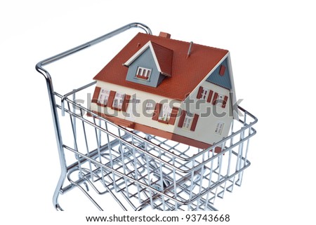 a model of a shell building in a shopping cart. photo icon for house purchase.