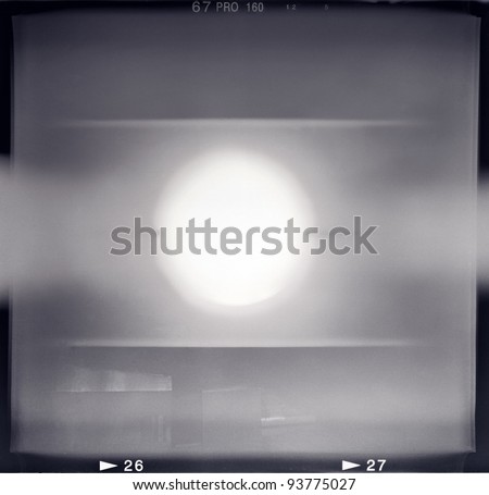 Blank medium format (6x6) monochrome film frame with abstract filling containing light leak in center