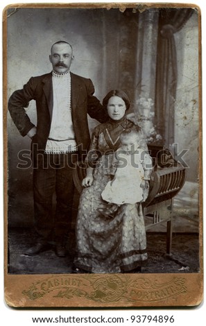 RUSSIA - CIRCA  the end of 19 - early 20 century: An antique photo shows couple with daughter, the Russian Empire