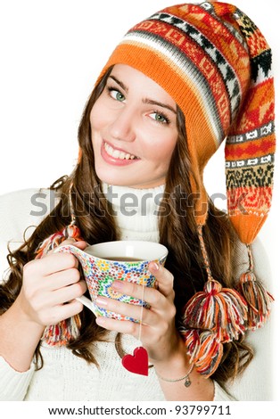 Young girl in orange hood and with cup of hot tea