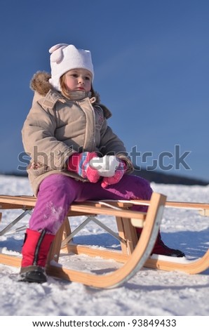 Happy child on a sled
