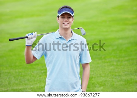 A young man with a stick on the golf course