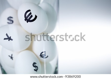 Image of eggs with currency signs in glass