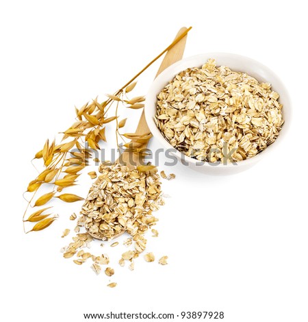 Rolled oats in a wooden spoon and a porcelain bowl, oaten stalks isolated on white background Royalty-Free Stock Photo #93897928