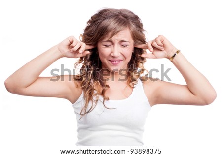 portrait of an angry young woman closing her ears and refusing to listen to something , isolated against purple studio background