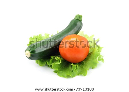 details of a fresh zucchini and tomato isolated on white on salad