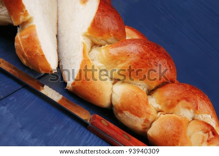 sweet bread : golden challah cuts over blue wooden plate