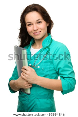 Portrait of a happy young attractive woman wearing doctor uniform, isolated over white