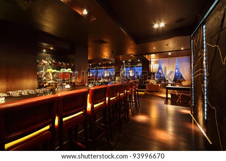 bar counter with chairs in empty comfortable restaurant at night Royalty-Free Stock Photo #93996670