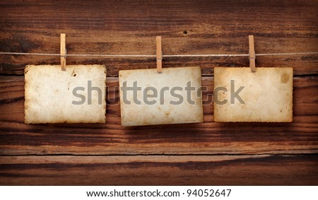 close up of an old photo and clothes peg on a wooden background