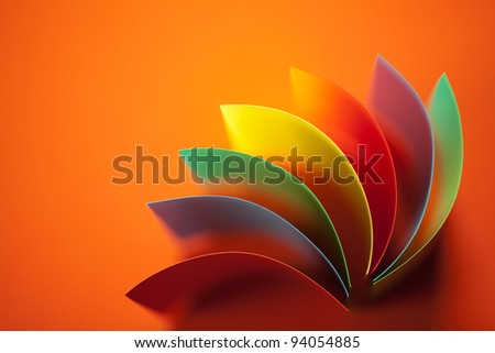 background image of colorful origami fan pattern made of curved sheets of paper, on orange background Royalty-Free Stock Photo #94054885
