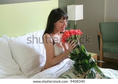 a woman at the bed with a roses