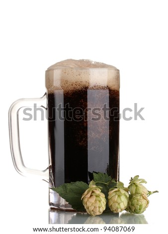 dark beer in a mug and green hop isolated on white