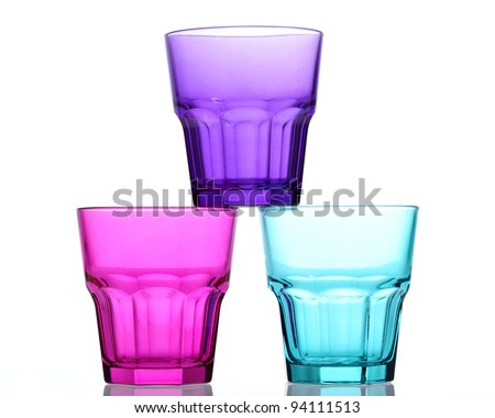 Three colored glasses one placed on two other like a pyramid
