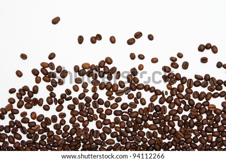 Scattered coffee beans on white background
