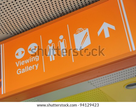 Directional signage indicating shopping areas, toilet and viewing gallery