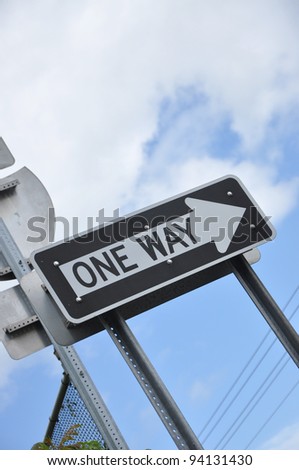 One Way Traffic Signs Blue Cloud Sky in Background