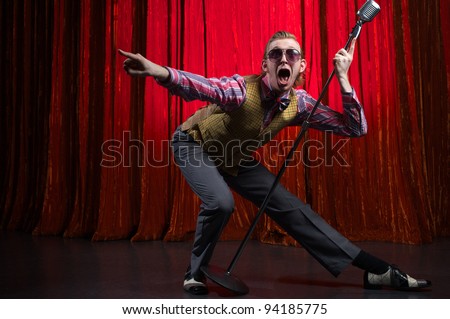 The man is stay on the stage in theatre Royalty-Free Stock Photo #94185775