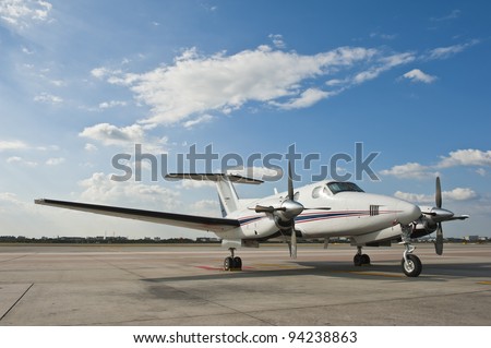 Propeller plane parking at the airport Royalty-Free Stock Photo #94238863