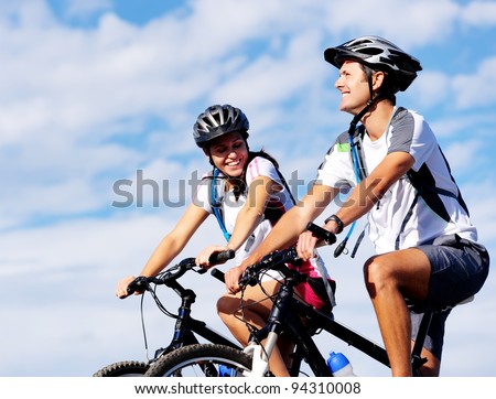 Happy carefree mountain bike couple cycling outdoors and leading a healthy lifestyle.